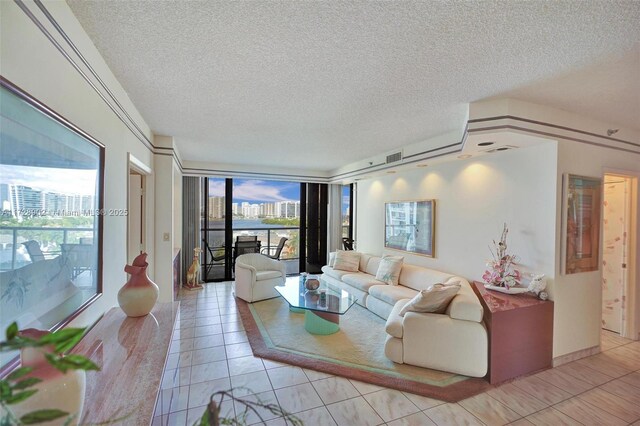 living room with a textured ceiling and light tile patterned flooring