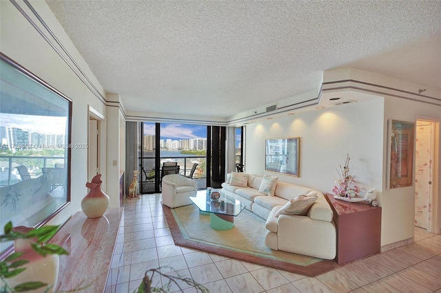 living room featuring floor to ceiling windows, a textured ceiling, and light tile patterned flooring