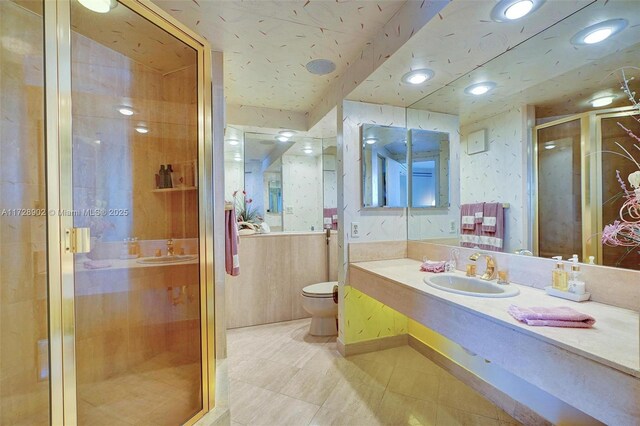 kitchen featuring appliances with stainless steel finishes, light tile patterned floors, sink, and wood ceiling