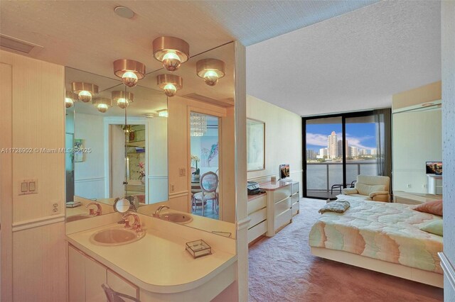 interior space featuring a textured ceiling, sink, and floor to ceiling windows