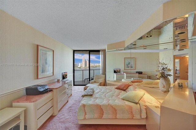 carpeted bedroom with access to outside, floor to ceiling windows, and a textured ceiling