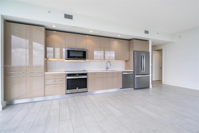 kitchen with tasteful backsplash, appliances with stainless steel finishes, and sink