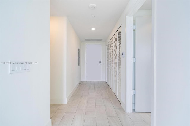 hallway featuring baseboards