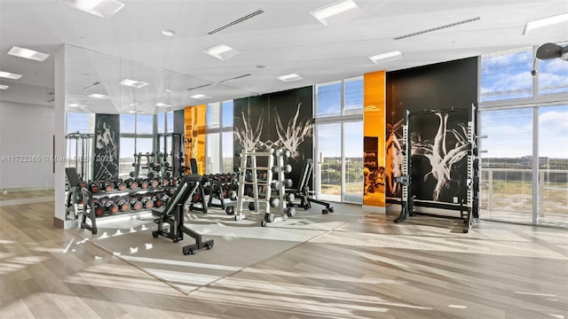 exercise room featuring a wall of windows and visible vents