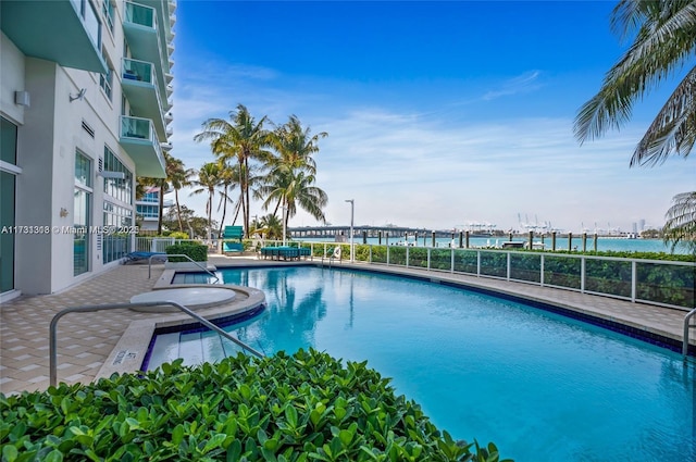 view of pool featuring a water view