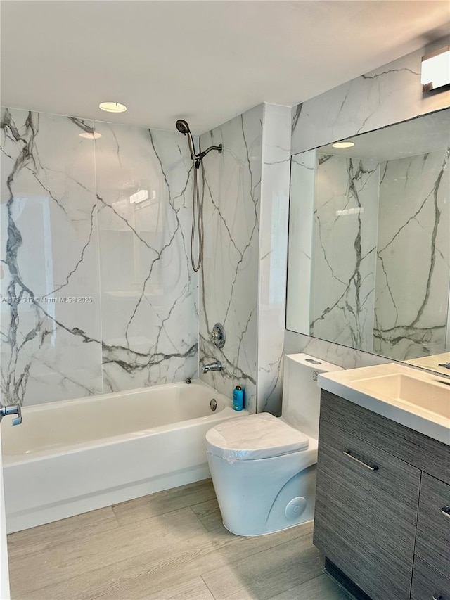 full bathroom with tiled shower / bath combo, vanity, and toilet