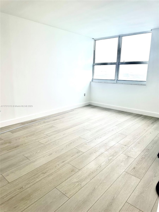 unfurnished room featuring light hardwood / wood-style flooring