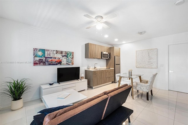 tiled living room featuring sink and ceiling fan