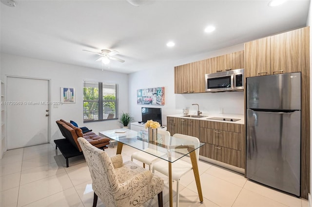 kitchen featuring ceiling fan, stainless steel appliances, sink, and light tile patterned floors