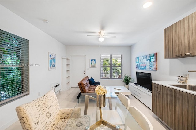 tiled living room featuring sink and ceiling fan