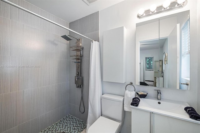 bathroom with vanity, toilet, and curtained shower