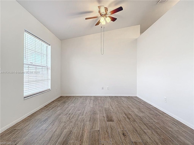 empty room with hardwood / wood-style flooring and ceiling fan