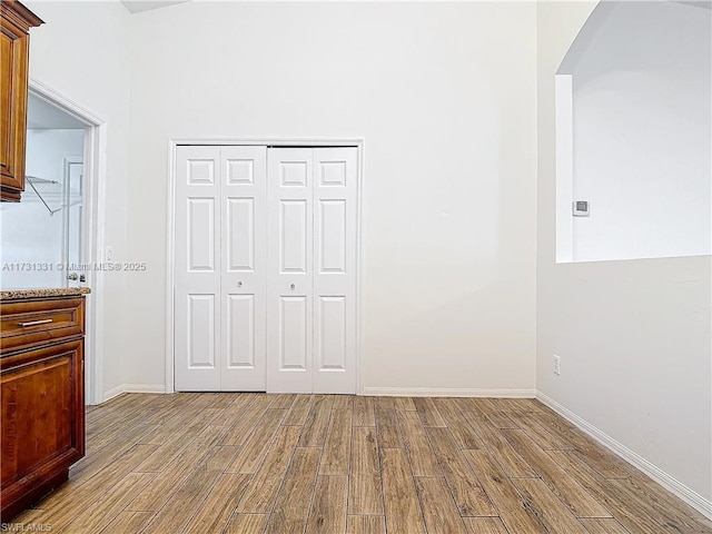 unfurnished bedroom with light hardwood / wood-style floors and a closet