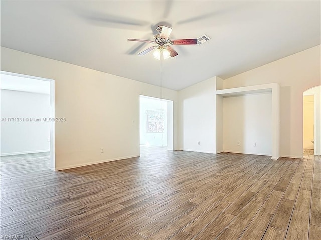 spare room featuring vaulted ceiling, hardwood / wood-style floors, and ceiling fan