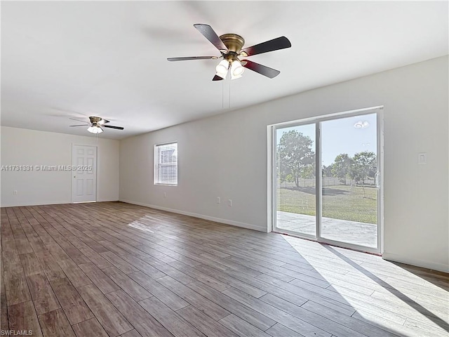 unfurnished room with hardwood / wood-style flooring and ceiling fan