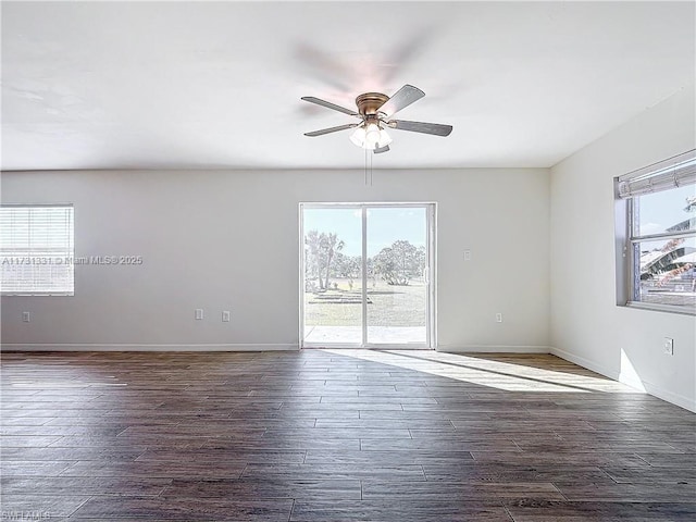 unfurnished room with ceiling fan and dark hardwood / wood-style flooring