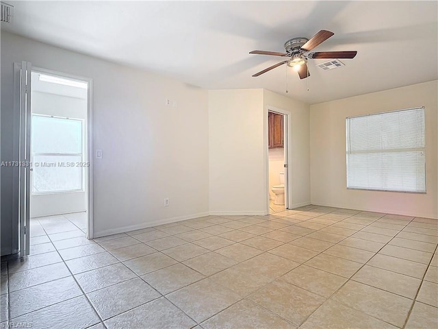 unfurnished room featuring light tile patterned flooring and ceiling fan