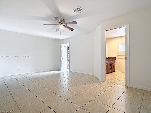 spare room featuring light tile patterned floors and ceiling fan