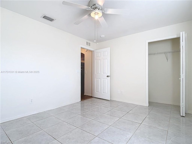 unfurnished bedroom featuring light tile patterned flooring, ceiling fan, and a closet