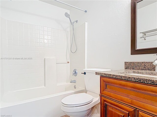 full bathroom featuring vanity, bathtub / shower combination, and toilet