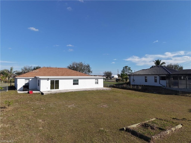 rear view of house featuring a yard