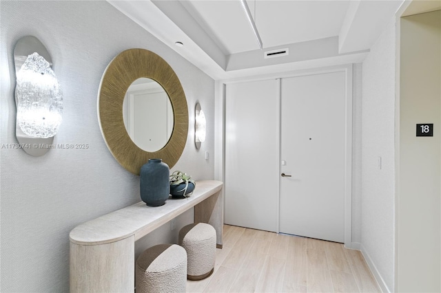 entrance foyer with wood finished floors and visible vents