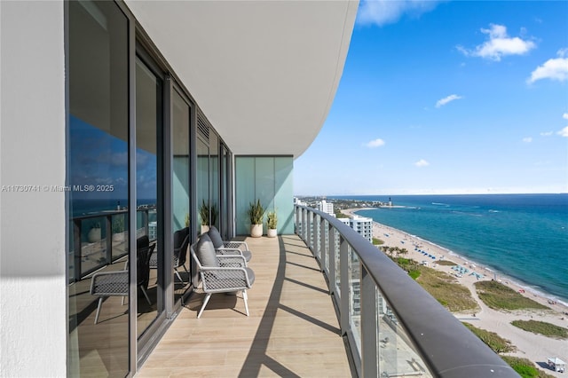 balcony with a beach view and a water view