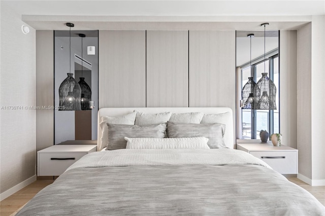 bedroom featuring light wood-type flooring and baseboards