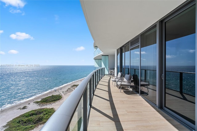 balcony with a view of the beach and a water view