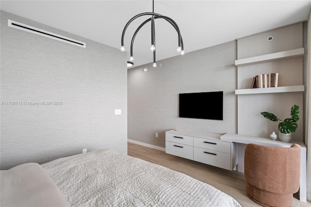 bedroom featuring light wood-style floors and baseboards