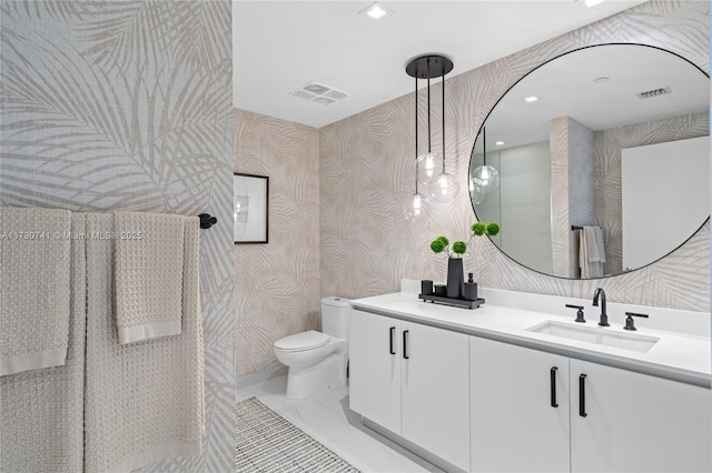 bathroom featuring visible vents, a sink, toilet, and wallpapered walls