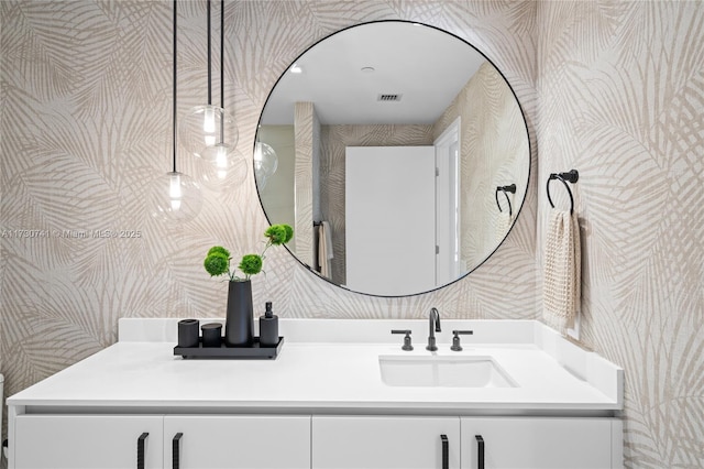 bathroom featuring wallpapered walls, visible vents, and vanity