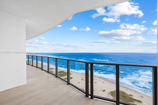 balcony with a water view and a beach view