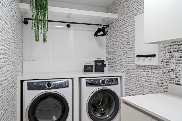 laundry area with cabinet space and washer and clothes dryer