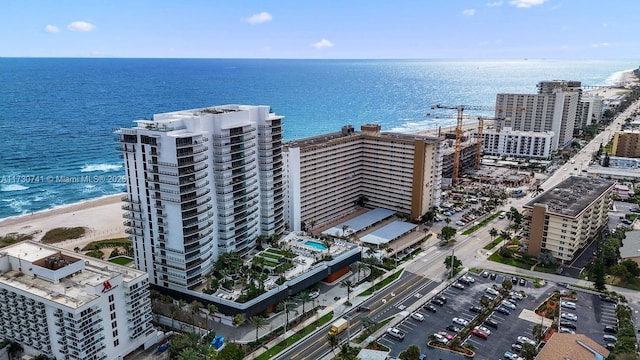 drone / aerial view featuring a water view and a beach view