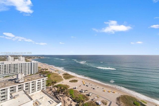 birds eye view of property featuring a water view and a beach view