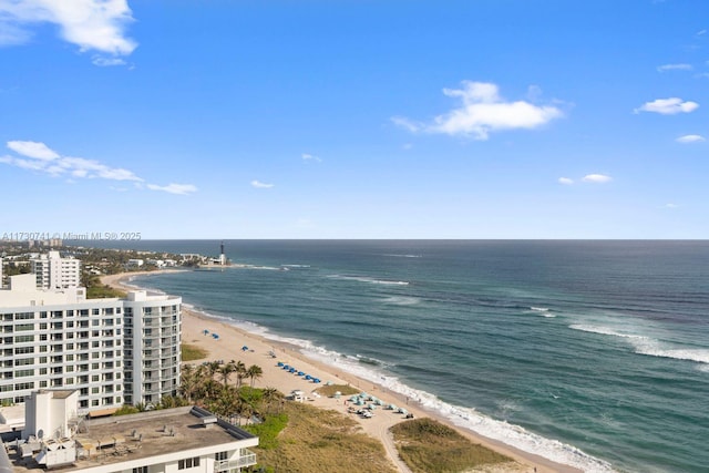 drone / aerial view with a water view and a beach view