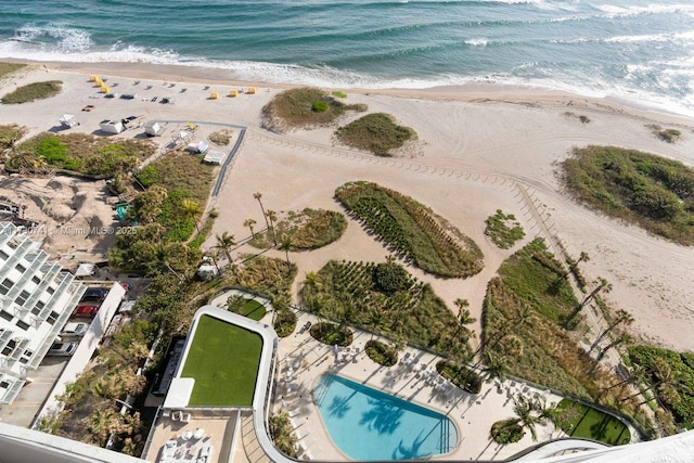 drone / aerial view with a water view and a view of the beach