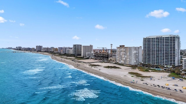 drone / aerial view featuring a water view and a beach view