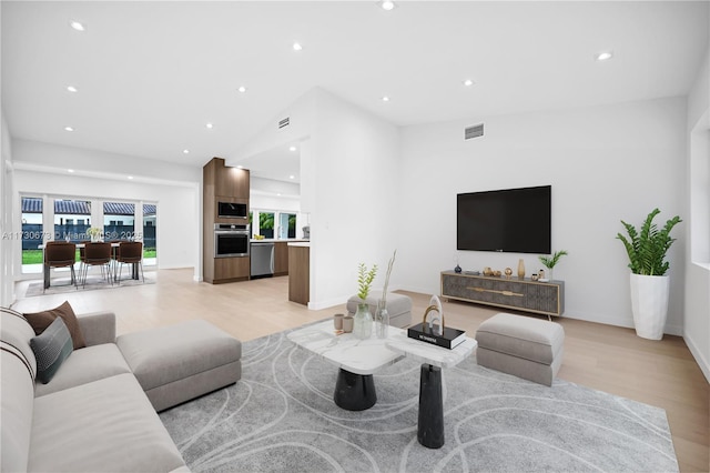 8745 SW 175th St, Palmetto Bay, FL 33157 - living room featuring light wood finished floors, recessed lighting, vaulted ceiling, and baseboards