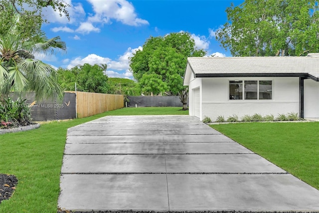 exterior space featuring a garage and a front lawn