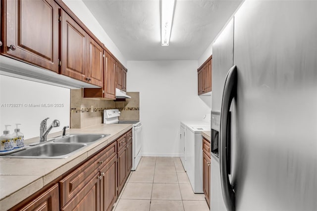 kitchen with sink, light tile patterned floors, stainless steel refrigerator with ice dispenser, decorative backsplash, and white electric stove