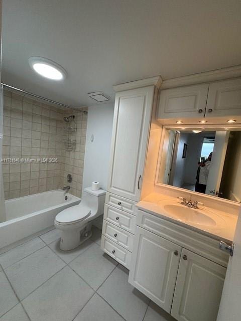 full bathroom featuring vanity, toilet, tiled shower / bath combo, and tile patterned flooring