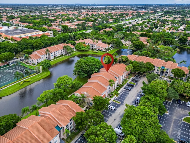 drone / aerial view with a water view and a residential view