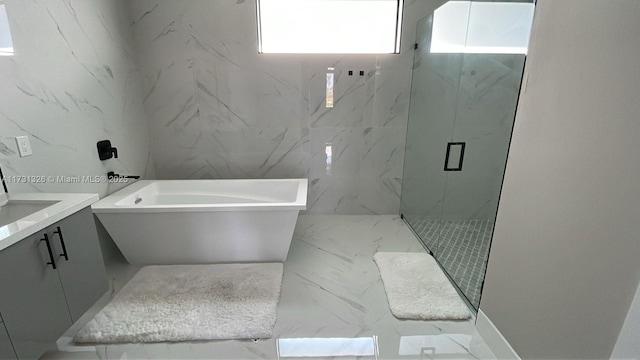 bathroom featuring shower with separate bathtub and vanity