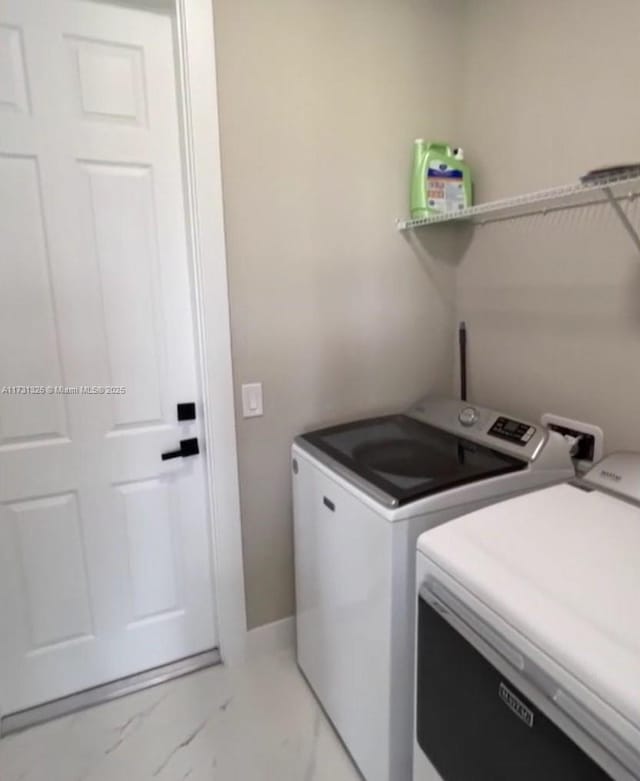 clothes washing area with washer and dryer