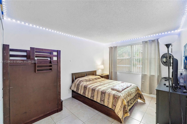 tiled bedroom featuring a textured ceiling