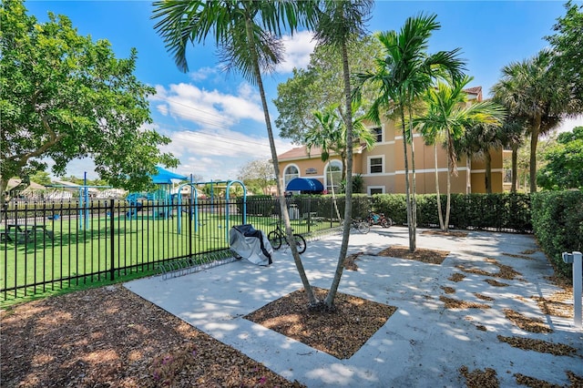 surrounding community featuring a playground and a yard