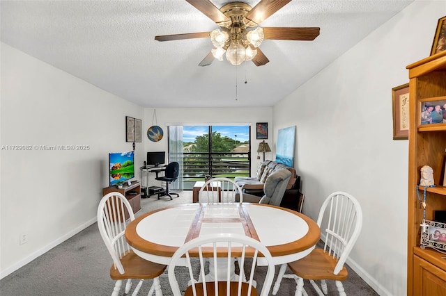 dining room with ceiling fan, light colored carpet, and a textured ceiling