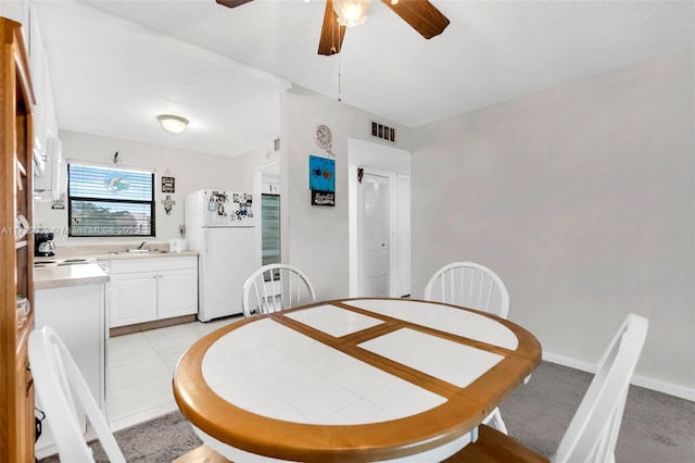 dining room featuring sink and ceiling fan